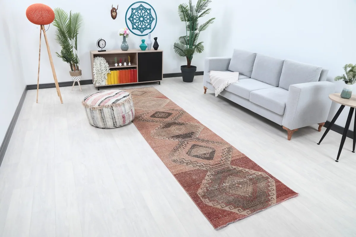 Angled view of the rose runner rug in a living space, showing its length and pattern