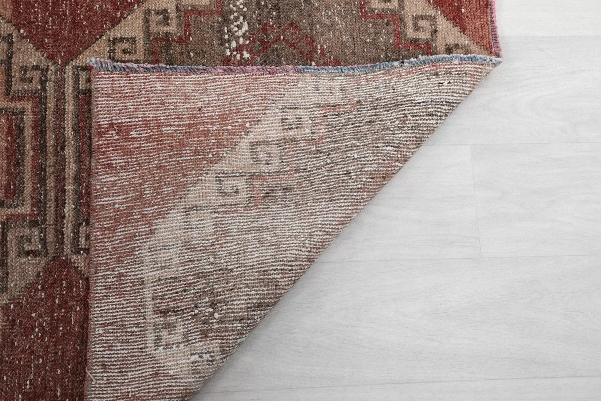 Close-up of the back of the rug, showing the tight hand-knotting and foundation weave