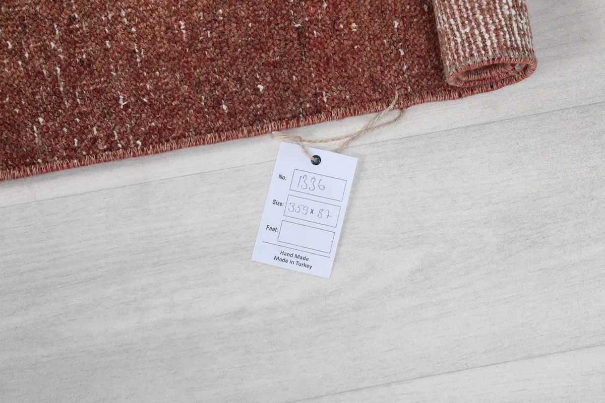Image showing the product tag with rug details, confirming hand-knotted wool and origin