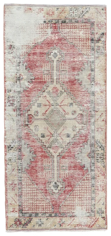 Full overhead view of the red and beige vintage Anatolian rug on a white background