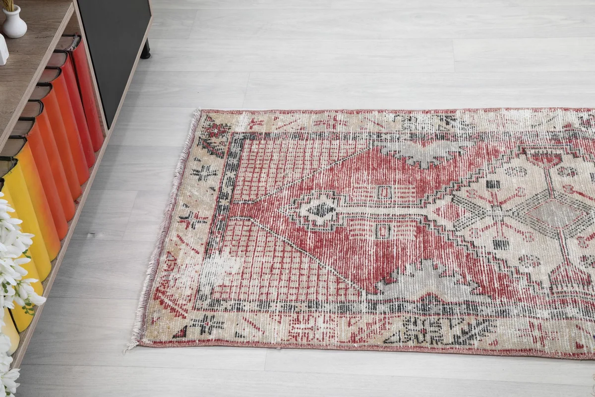 Side view of the rug's length, showcasing its overall distressed texture and design