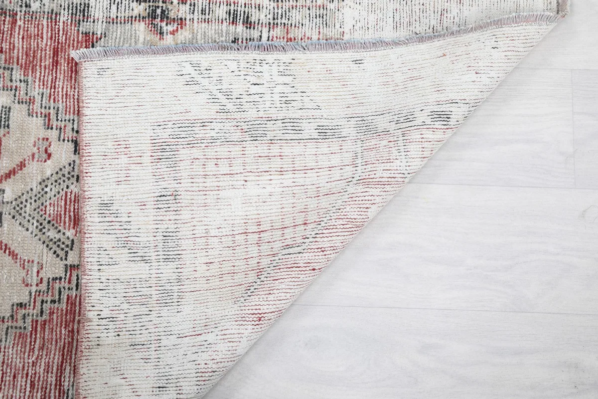 Another view of the rug's underside, showing the reverse of the hand-knotted construction