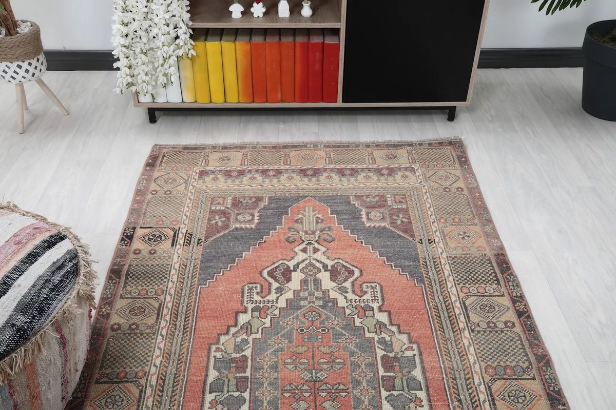 View of the vintage rug from one end in a room, showing its placement relative to furniture