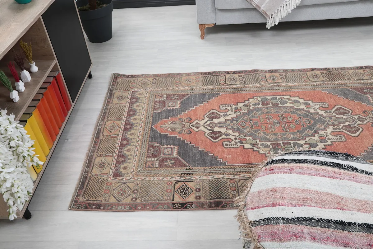 Angled view of the rug in a living space, showing its full length and colors