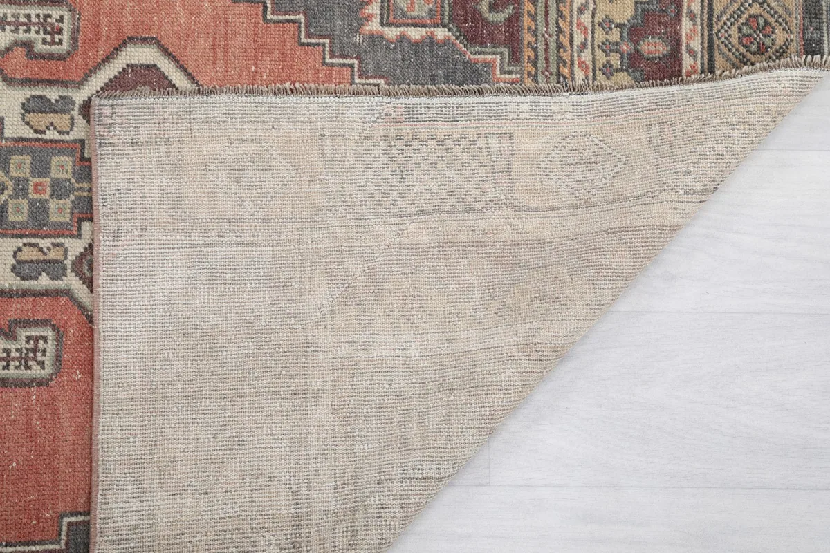 Close-up of the rug's reverse side, showing the tightly woven cotton foundation