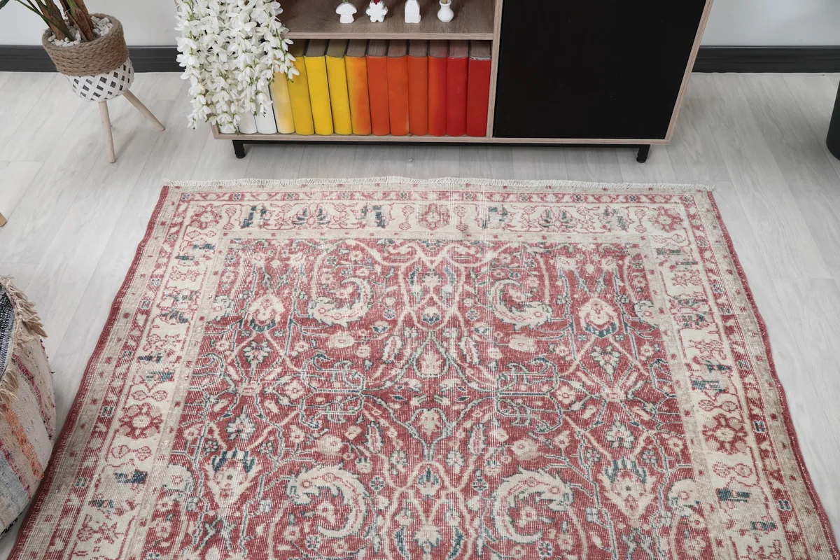 Overhead view of the rug in a room setting, showing its full design and surrounding decor.