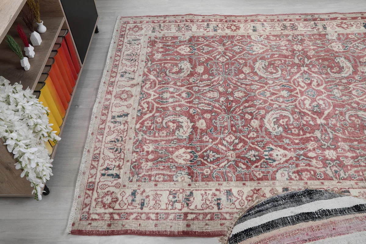 Wide angle view of the rust rug in a living space, demonstrating its size and visual impact.