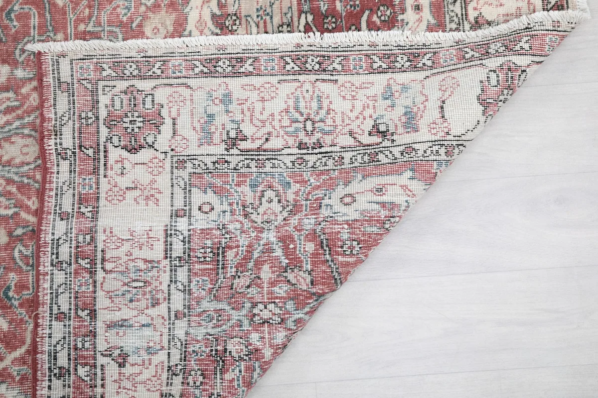 Close-up of the rug's reverse side, showing the tight hand-knotted construction and fringe.
