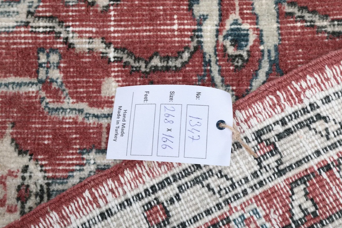 Information tag on the back of the rug, displaying its dimensions and origin.