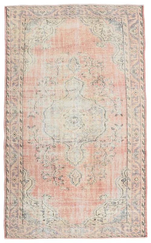 Full overhead view of the rose and gray vintage Anatolian area rug on a white background