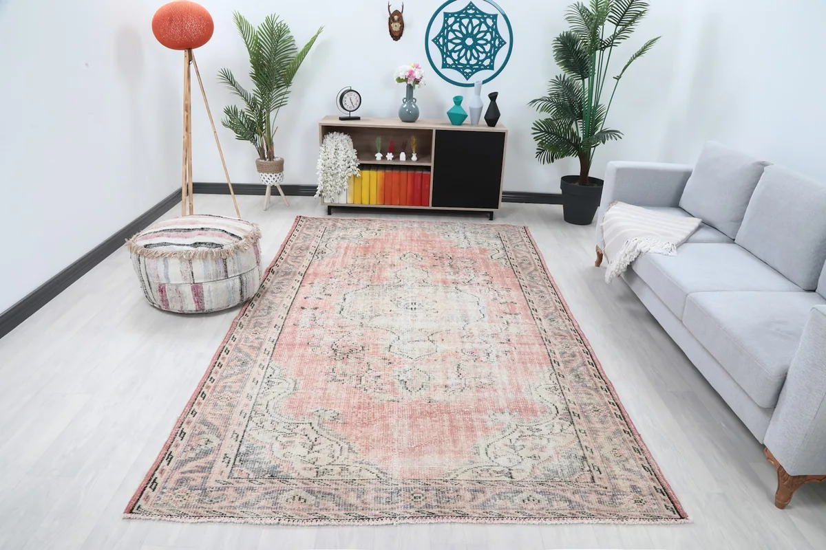 Anatolian rug displayed in a bright living room setting with a gray sofa and wooden furniture