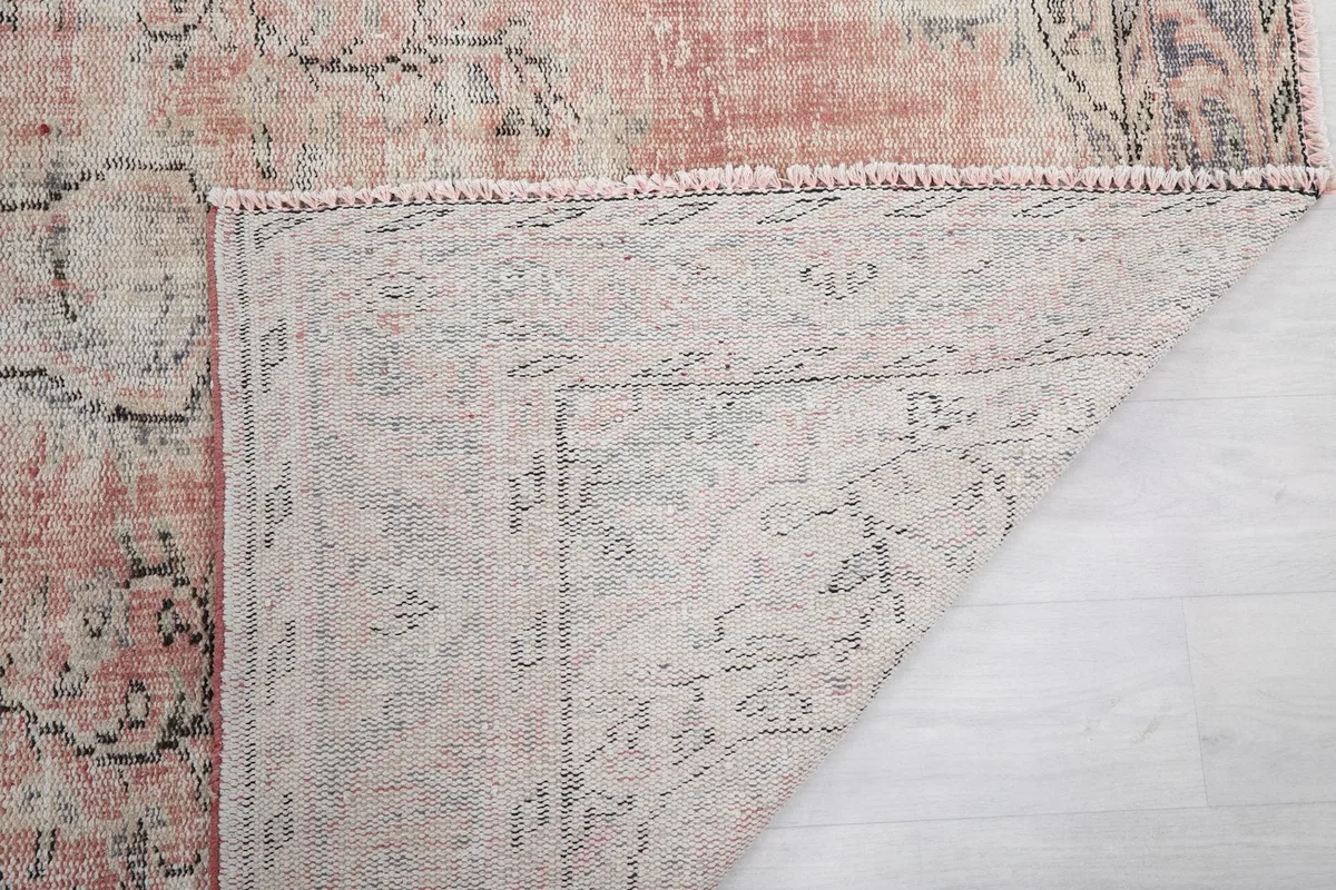 Another view of the rug's underside, showing the reverse side of the hand-knotted wool pile