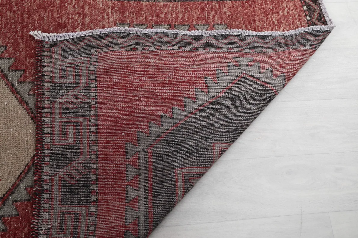 Underside of the rug showing the reverse of the hand-knotted construction and foundation.