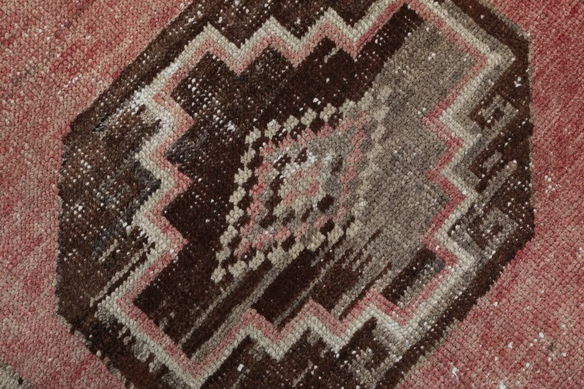Close-up of a central medallion, highlighting the intricate geometric motifs and color variations