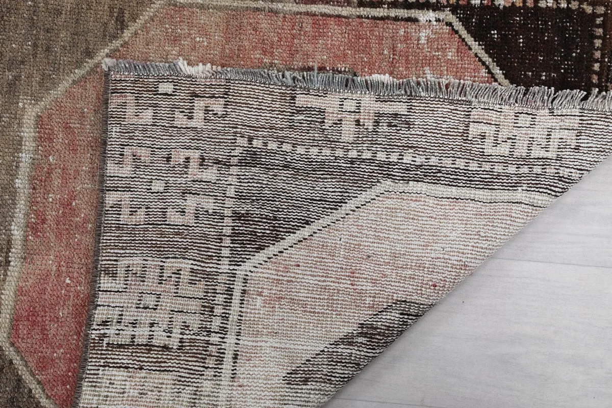 Close-up of the back of the rug, showing the knotting and texture of the foundation