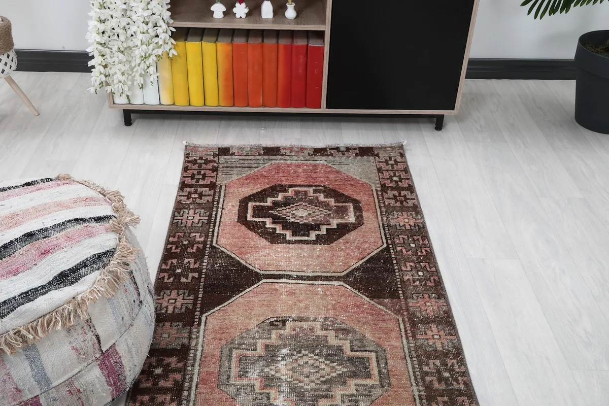 Overhead view of the runner rug in a room, focusing on the upper section and surrounding furniture