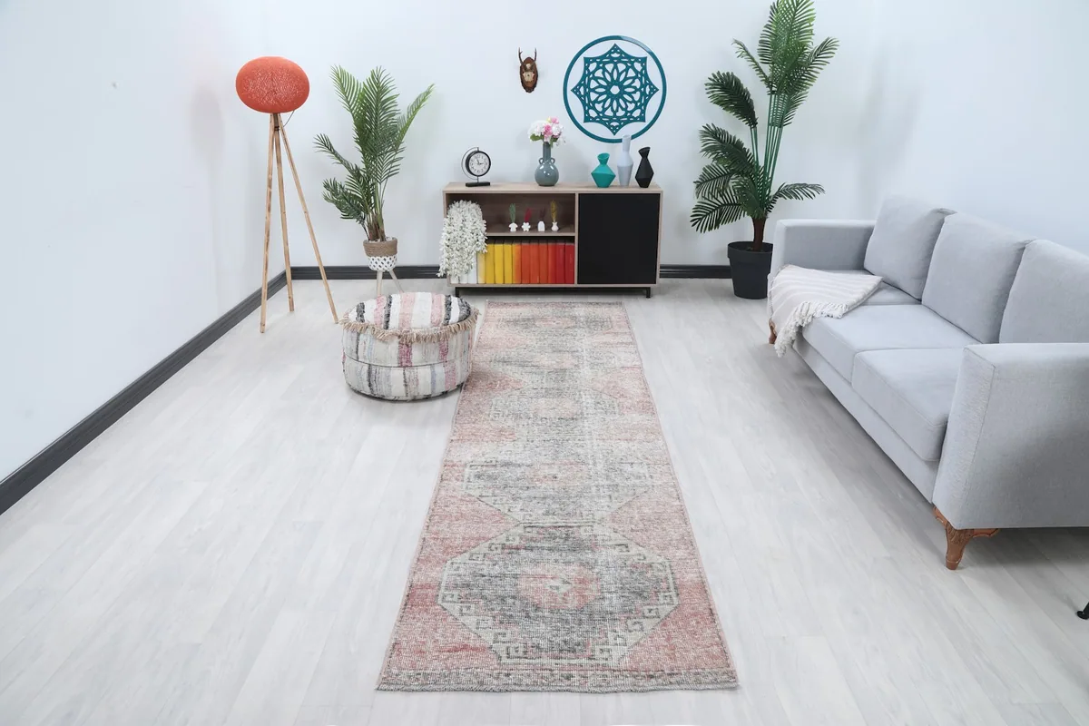Vintage Anatolian runner rug in a modern living room setting, showcasing its length and colors.