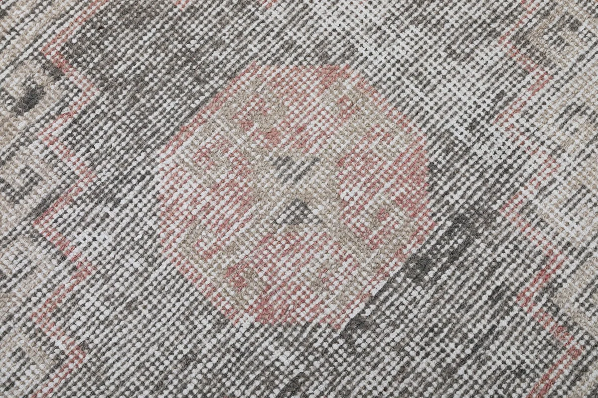 Close-up of the low wool pile texture and distressed rose and gray colors of the vintage runner.