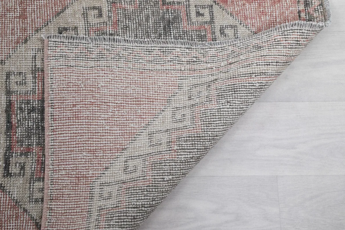 Another view of the back of the vintage runner, showing the knotting and foundation structure.