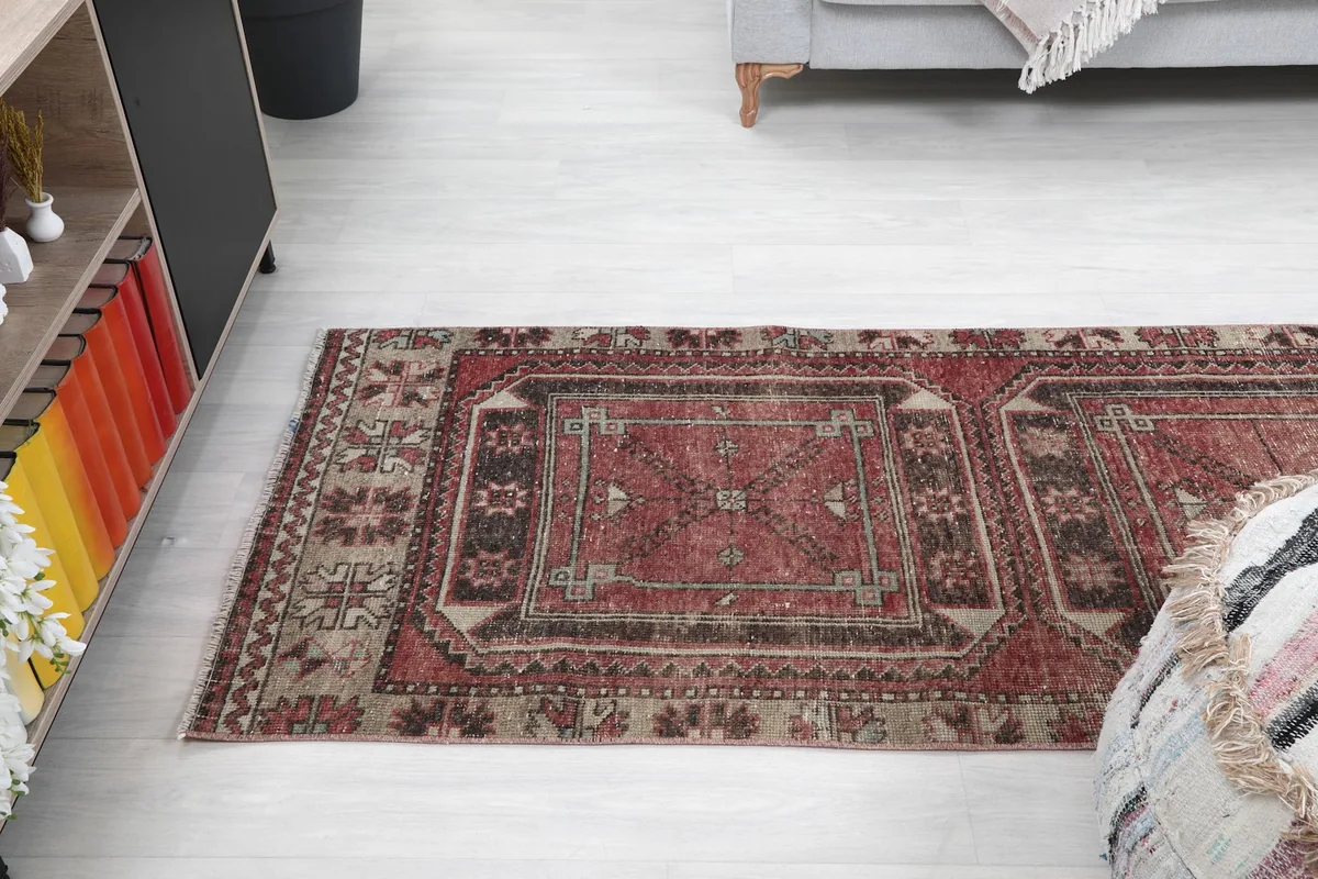 Overhead view of the red runner rug placed in a room, showing its length and design flow.