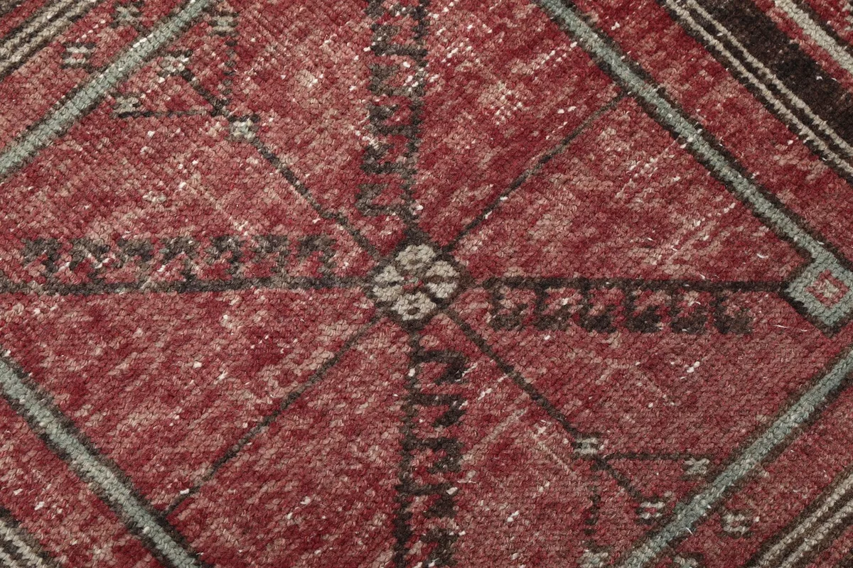 Close-up of the low wool pile, revealing the intricate knotting and subtle color variations.