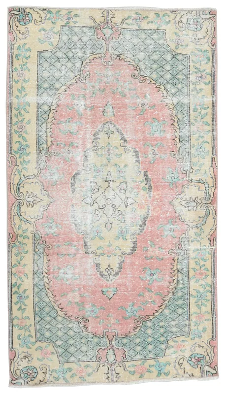 Full top view of the vintage Anatolian rug with a rose medallion and ivory border on a white background