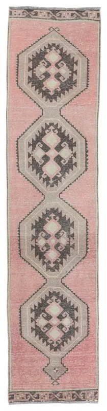Full top view of the rose and gray geometric Anatolian runner on a white background