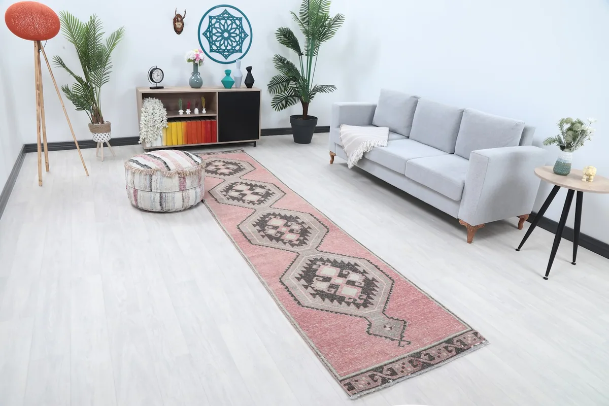 Overhead angle view of the rose runner rug in a room, showing its length and design