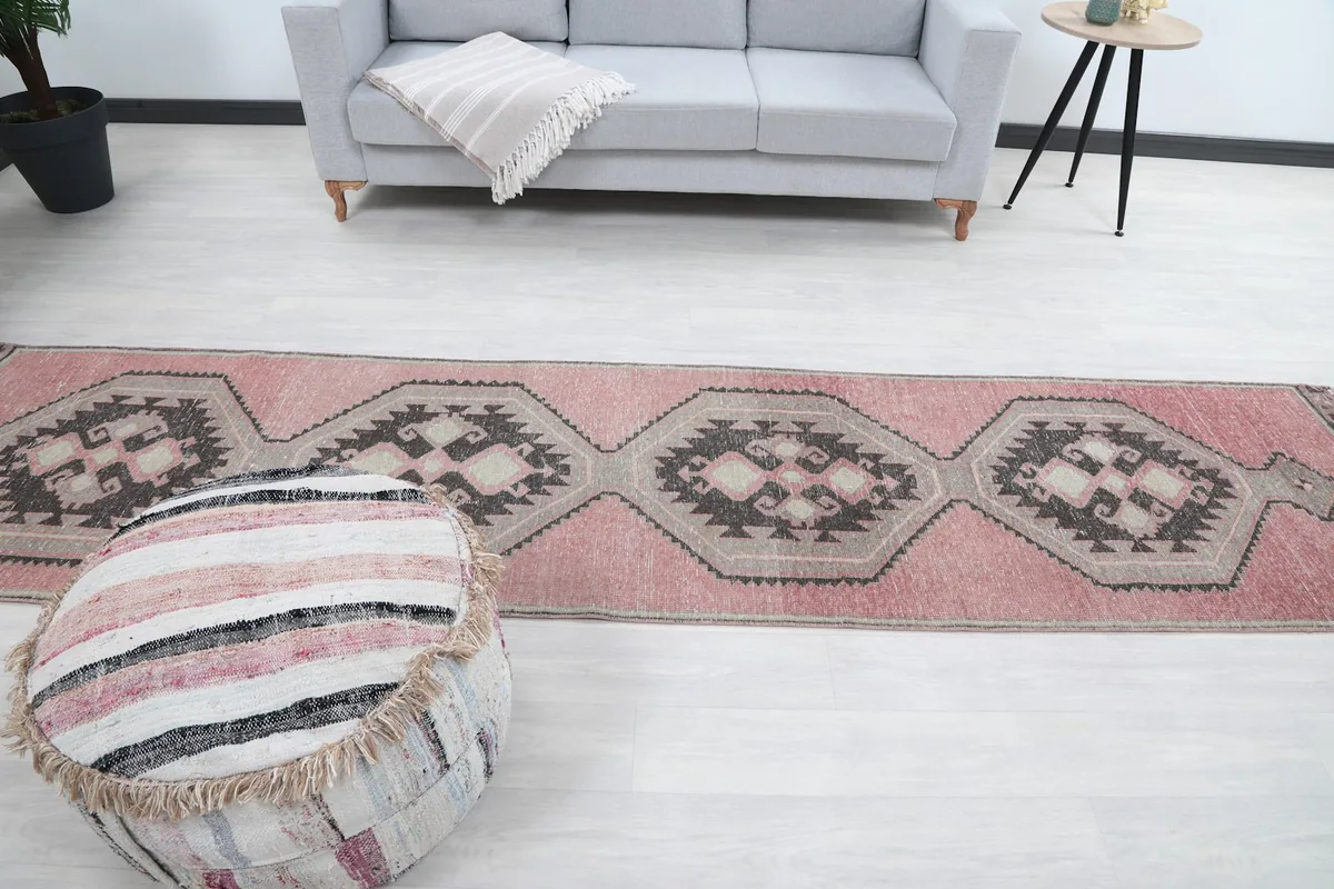 View of the rose runner rug extending down a room, highlighting its long length