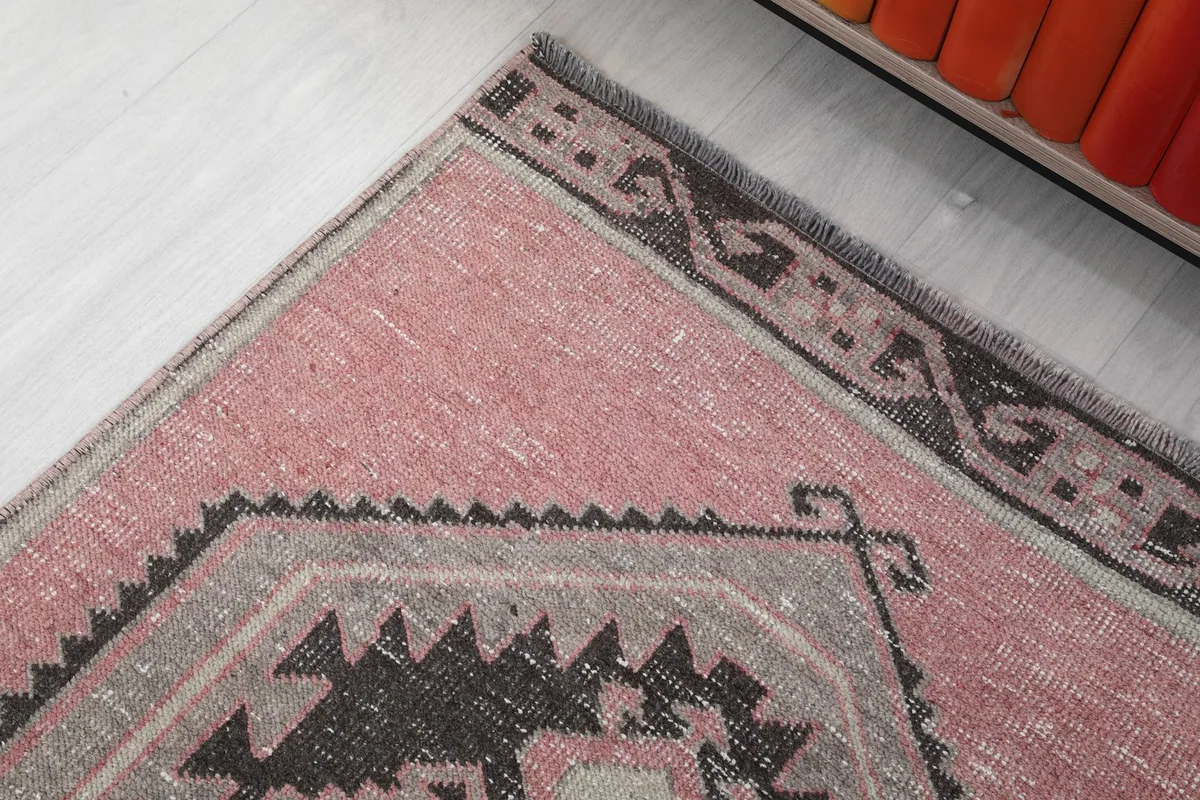 Corner detail of the runner rug, showing the border design and color variations