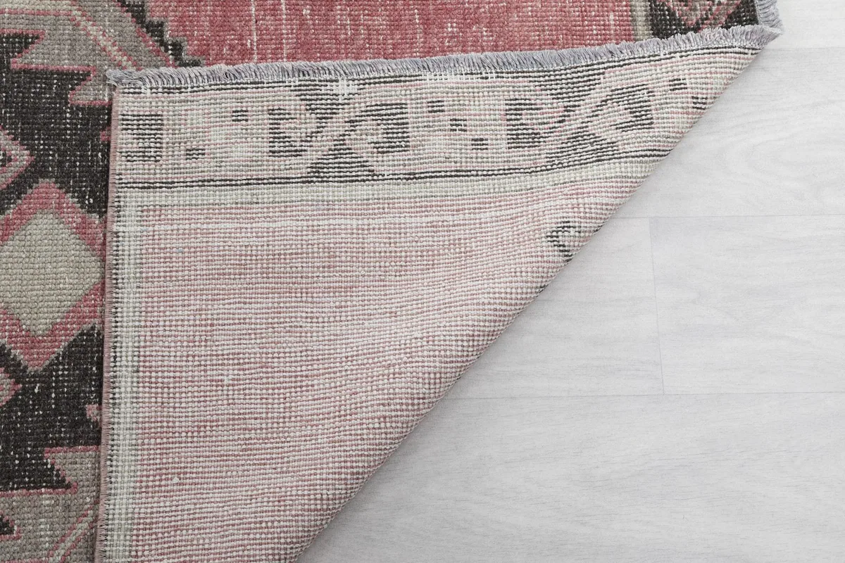 Another view of the rug's back, showing the hand-knotted construction and foundation