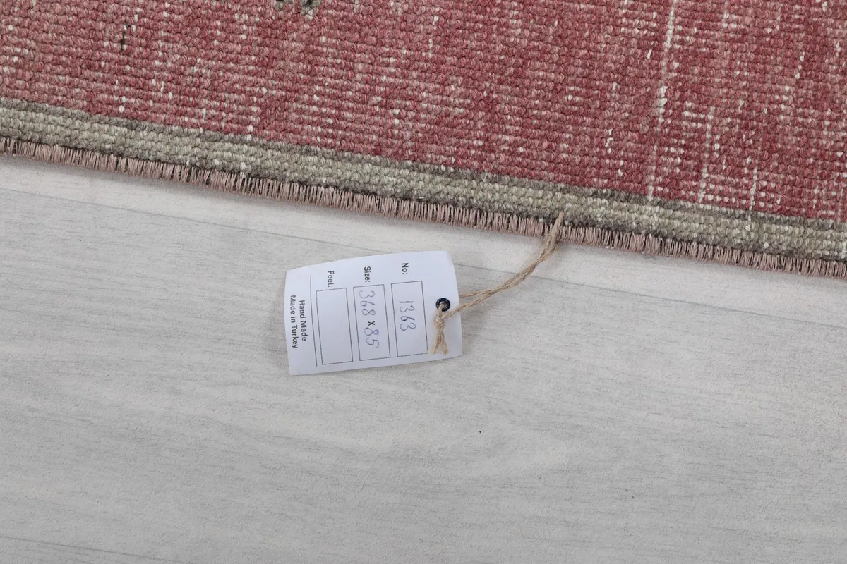 Close-up of the product tag attached to the rug, showing item details
