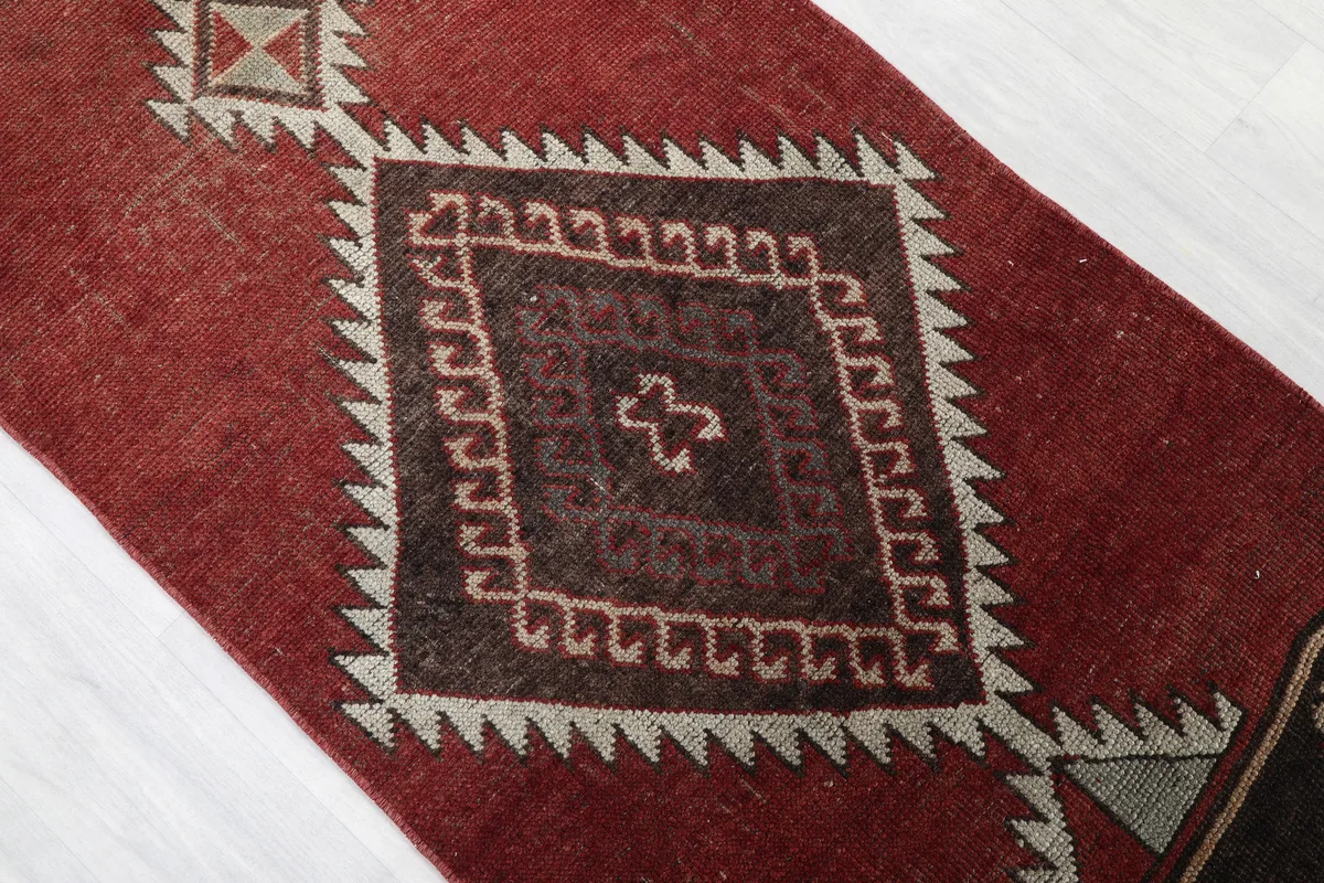 Rustic Red Tribal Diamond Runner, detail of a central brown diamond motif with beige accents
