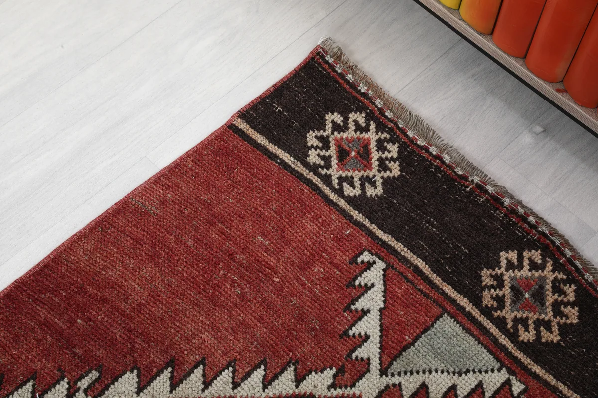 Rustic Red Tribal Diamond Runner, corner detail showing the border and a small geometric motif
