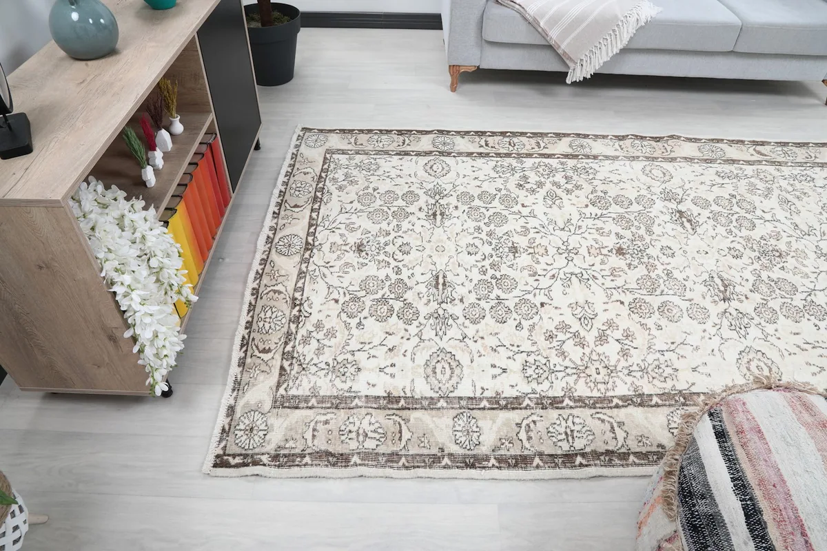 Wide shot of the ivory floral rug in a room, showing its scale relative to other decor