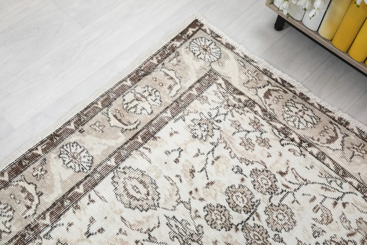 Corner detail of the rug, illustrating the intricate border design and field pattern