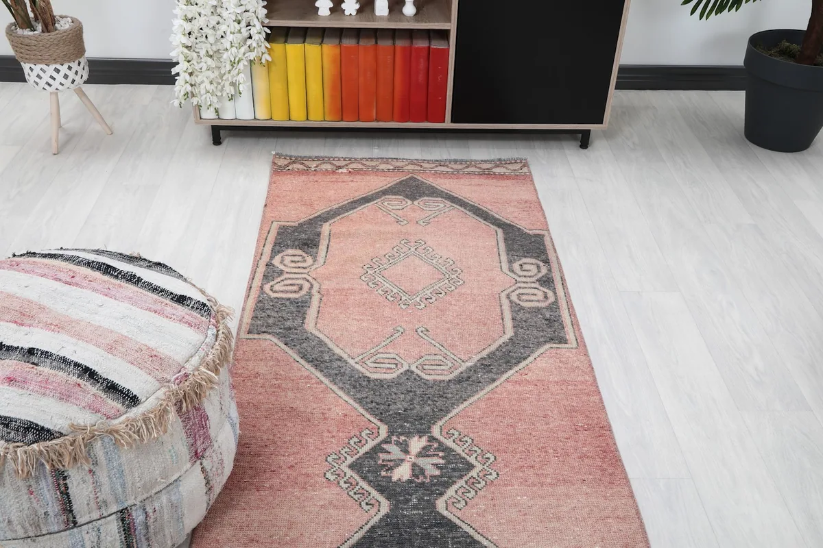 View of the runner rug stretching down a hallway, showing its proportion with furniture.