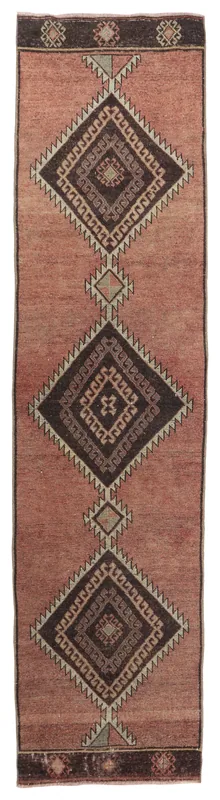 Full overhead view of the rose tribal geometric runner rug with brown and charcoal diamond patterns on a white background
