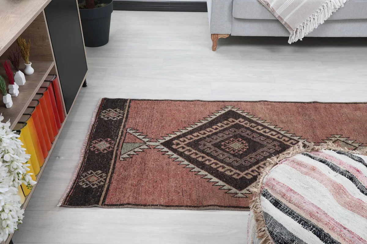 Angle view of the runner rug from the middle, showing the patterns extending towards the end