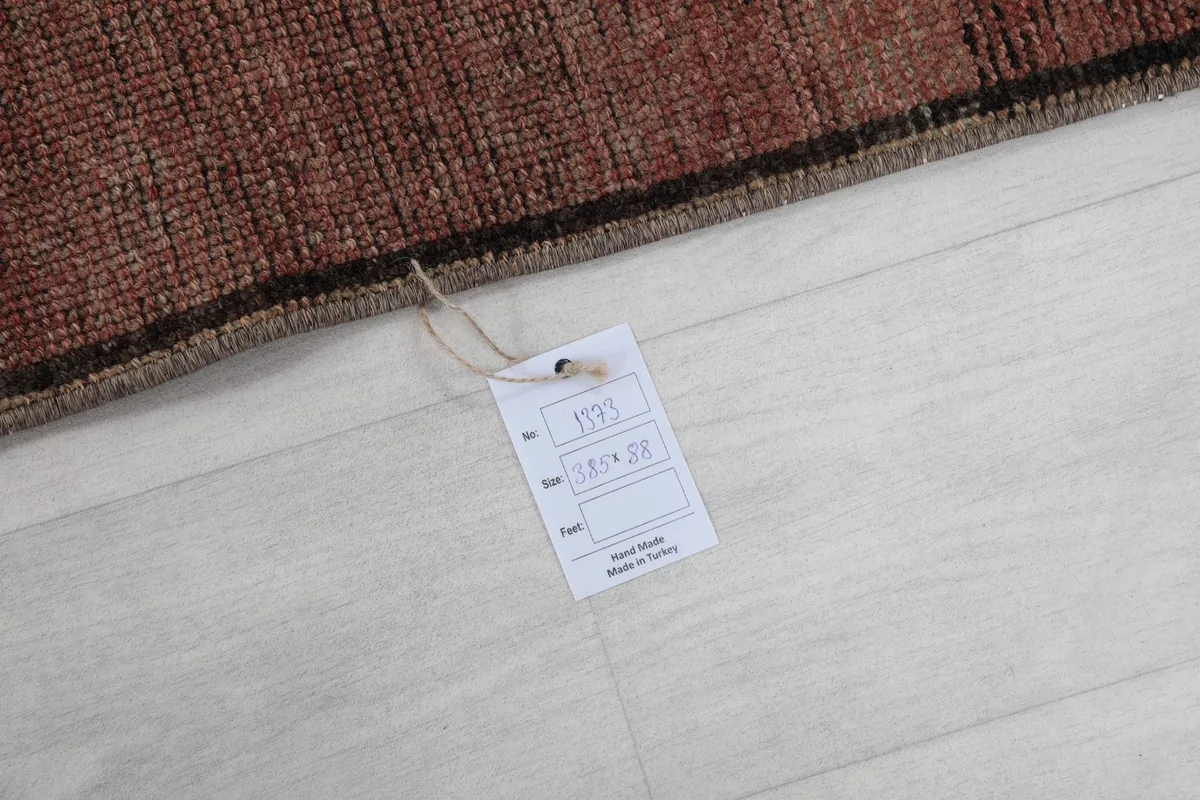 Corner of the runner rug with a product tag displaying size information
