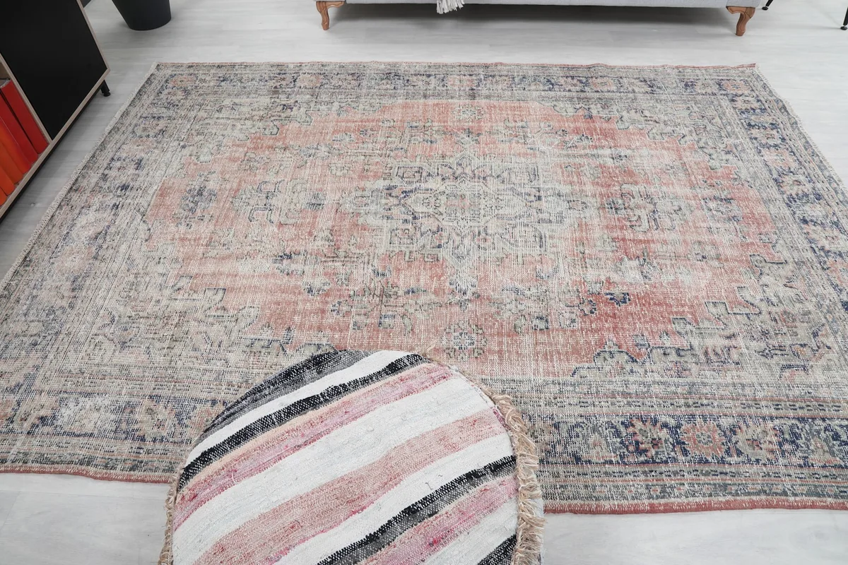 Full overhead view of the rust and navy vintage Anatolian rug, showcasing its complete design and distressed appearance.
