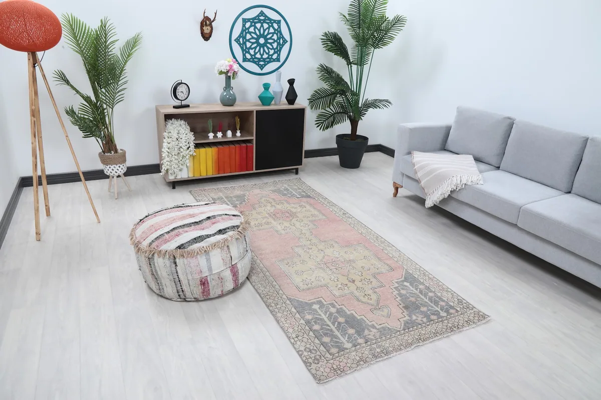 Angle view of the pink and beige geometric rug in a modern living space