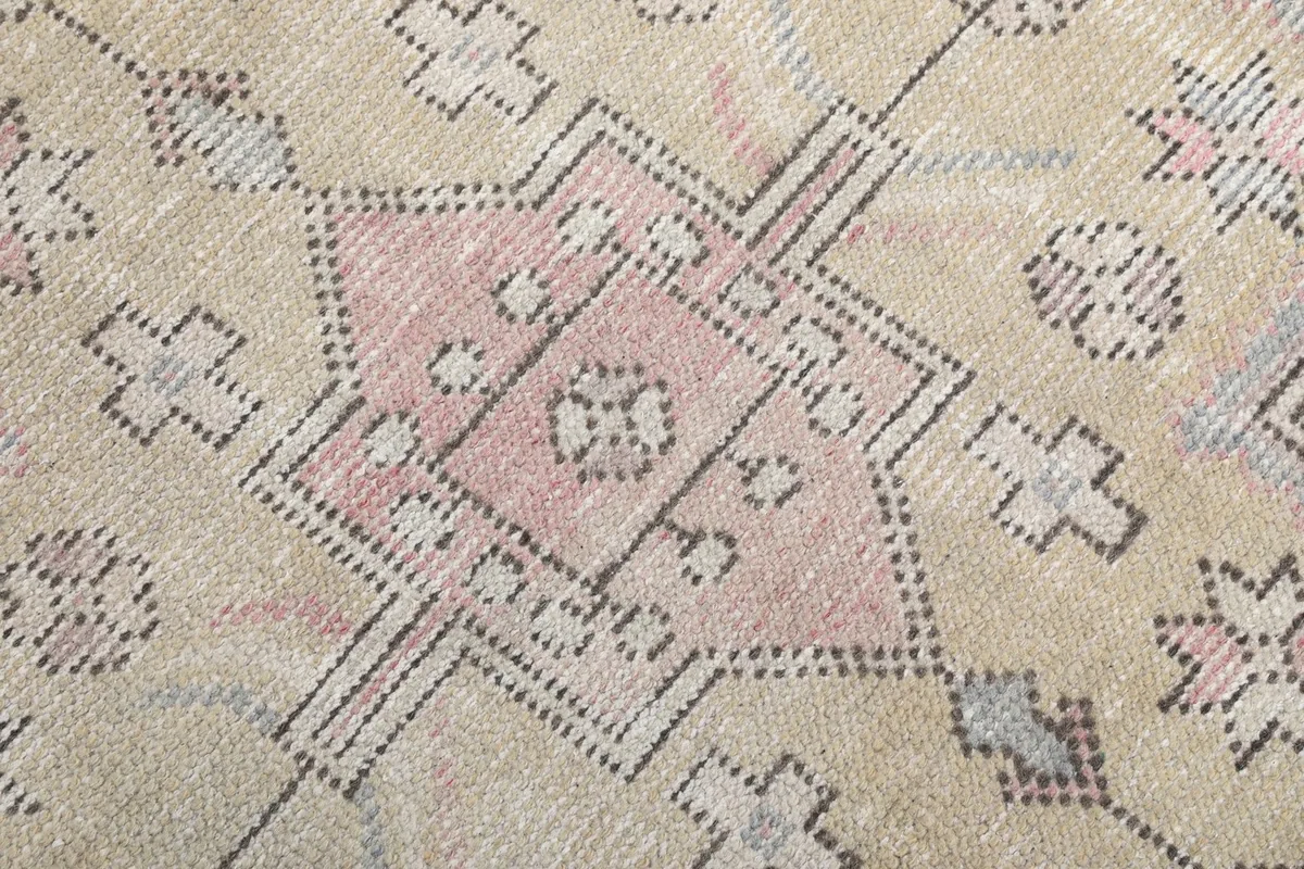 Close-up detail of the intricate geometric patterns within the rug's central medallion