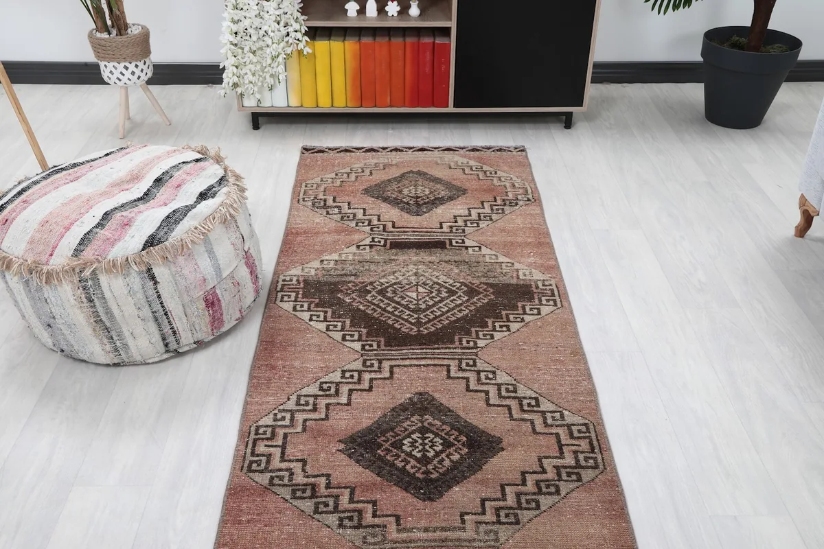 Overhead view of the rose geometric runner rug laid out in a hallway-like room