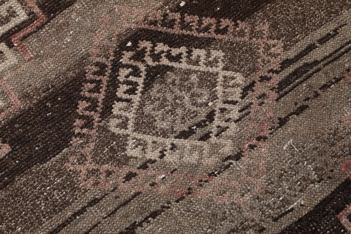 Extreme close-up showing the wool pile texture and intricate geometric knotting