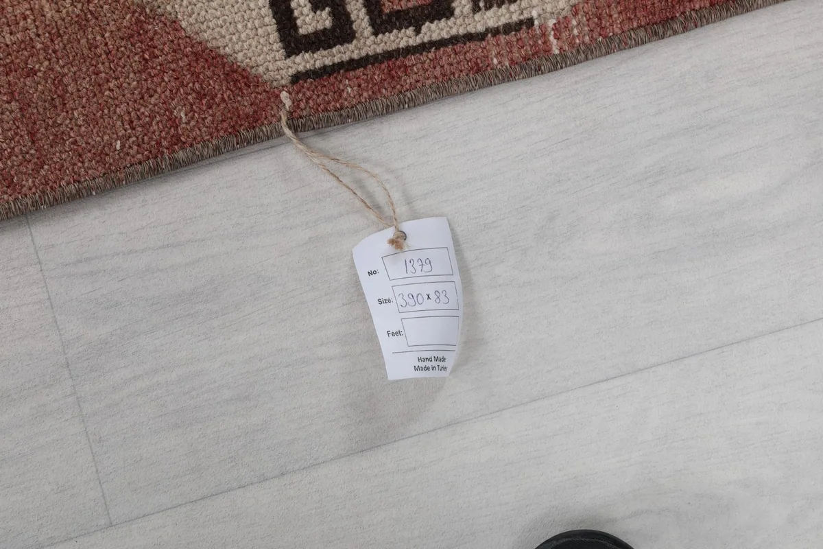 Close-up of the product tag attached to the rug, showing details like size and origin