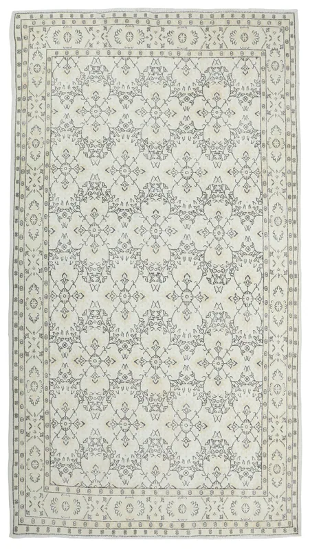 Full overhead view of the 7x10 ivory and gray vintage Anatolian area rug on a white background