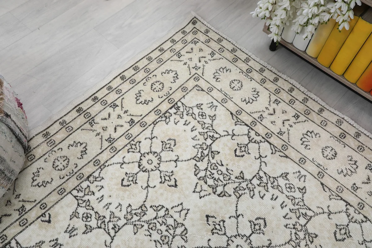 Corner view of the rug, showing the detailed border and the transition to the main field pattern