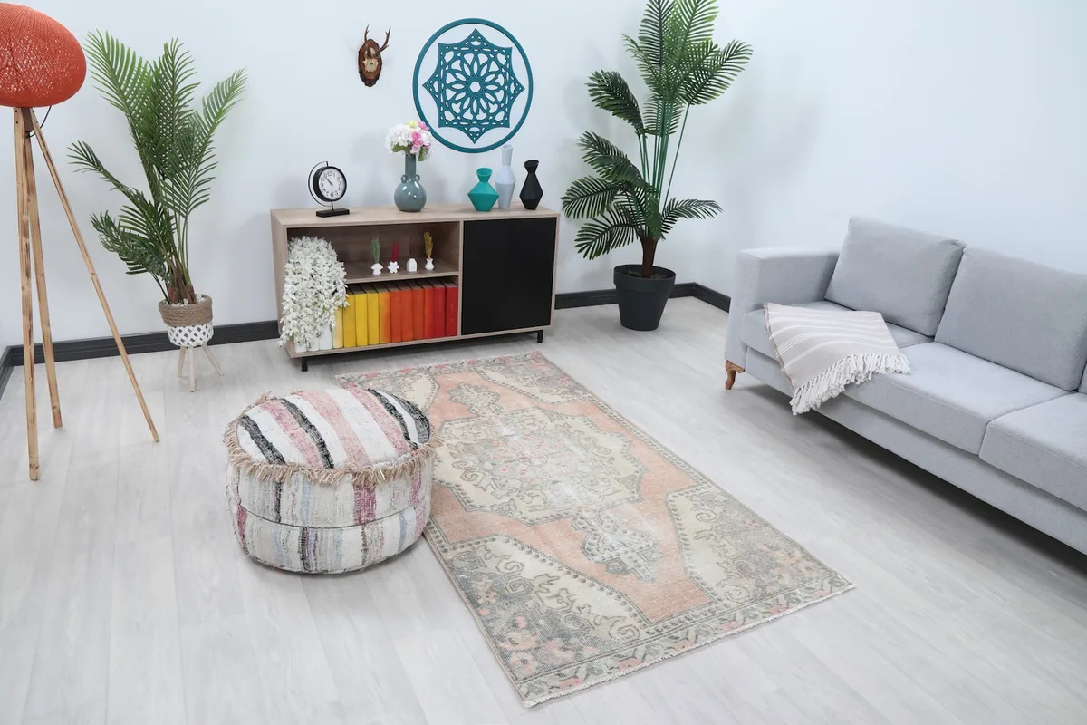 Angle view of the rose and gray vintage rug in a modern living space, showing its placement.