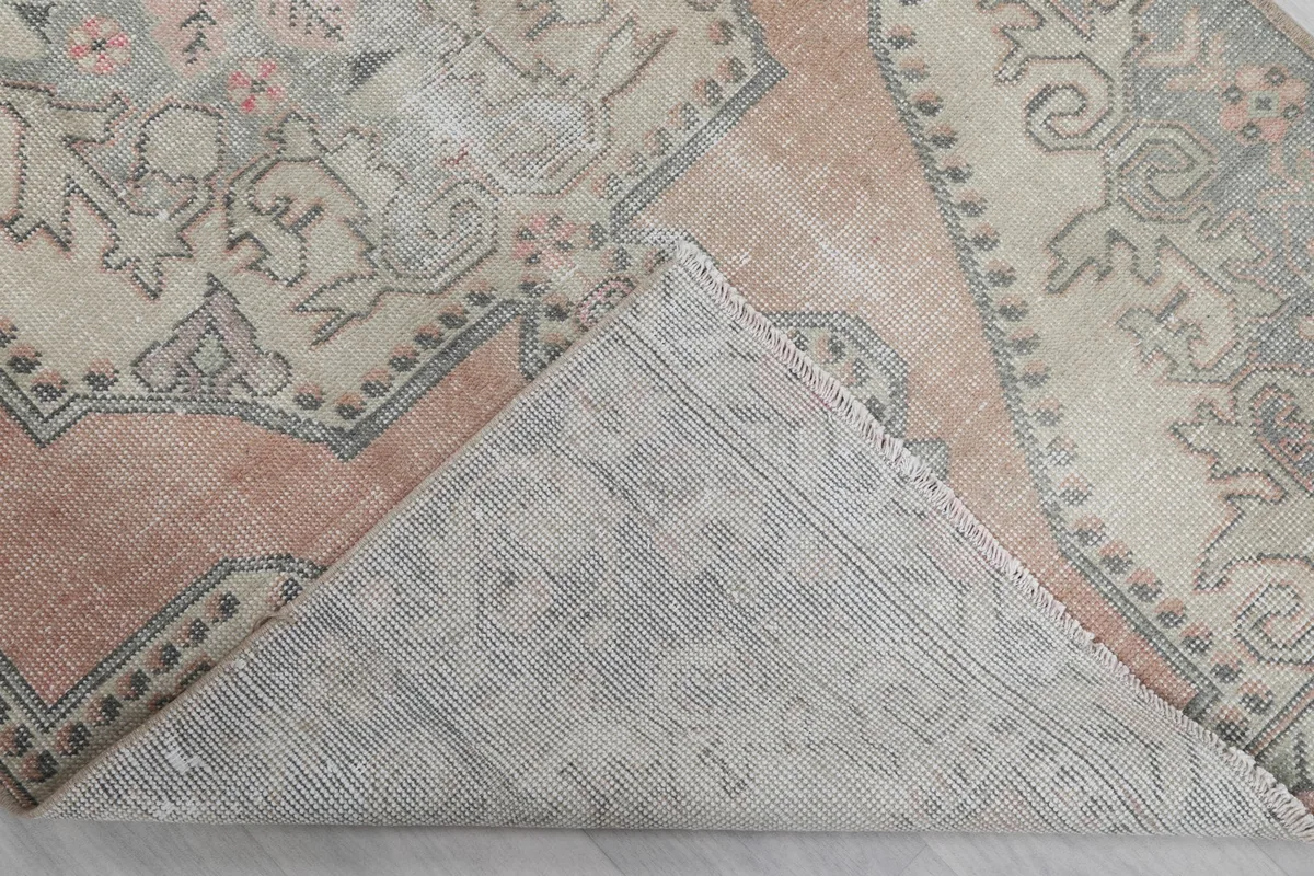 Underside view of the rug, revealing the hand-knotted cotton foundation.
